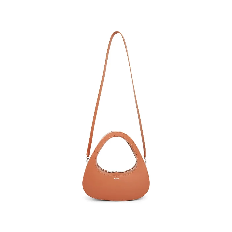 Bucket bags with patent leather finishes for a glossy, high-shine appearance-Crossbody Baguette Swipe Bag in Clay